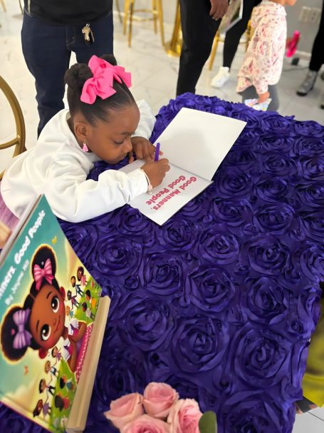 Jayme signing a book at her book signing